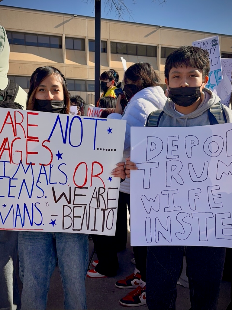 Edison High School students hold signs protesting ICE during a student-led march to the municipal building in Edison, New Jersey
